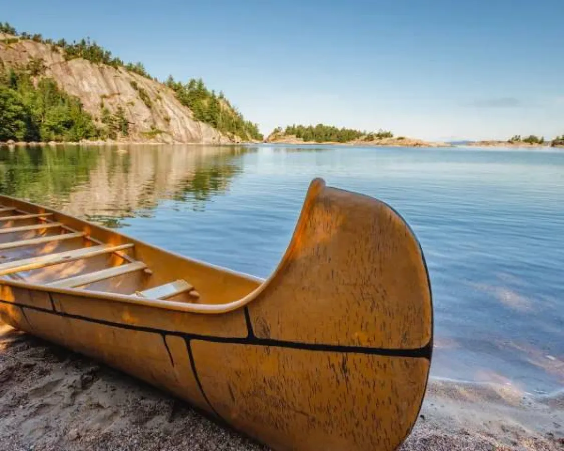 Canoe sitting on a lakeshore